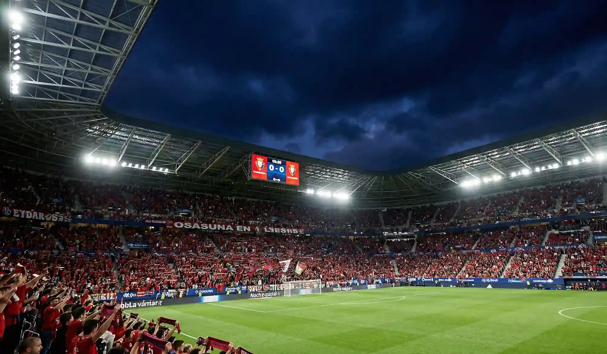 Estadio El Sadar iluminado en una noche de partido con atmósfera espectacular